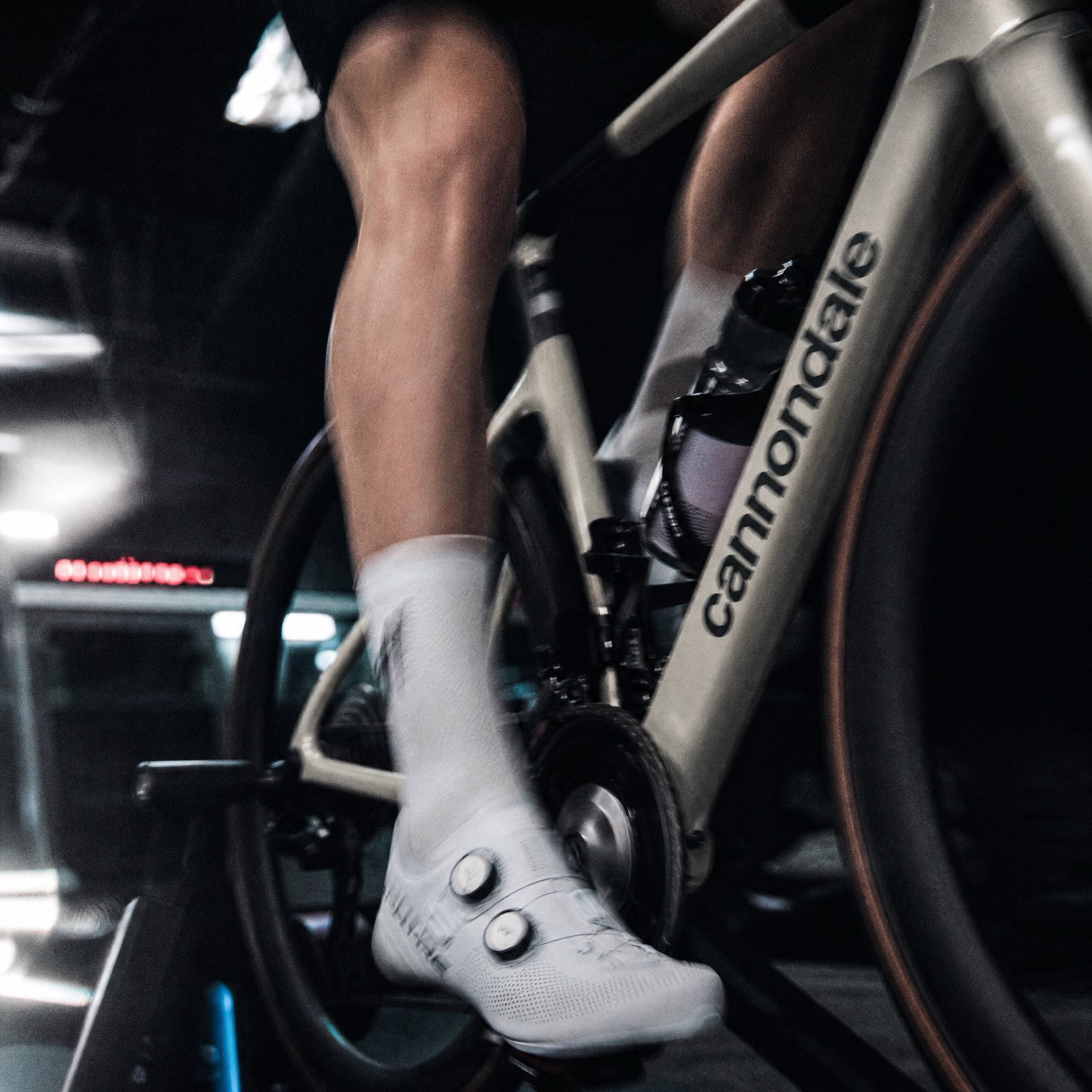 A shoe clipped into the pedal, the crank mid-stroke.
